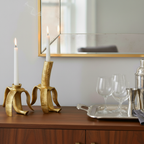 Gold taper candle holders styled on a table