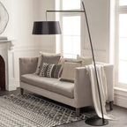 Astro arc floor lamp beside a sofa
