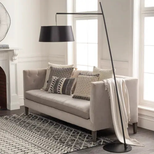 Astro arc floor lamp beside a sofa