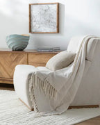 Prolo cream throw styled on a sofa