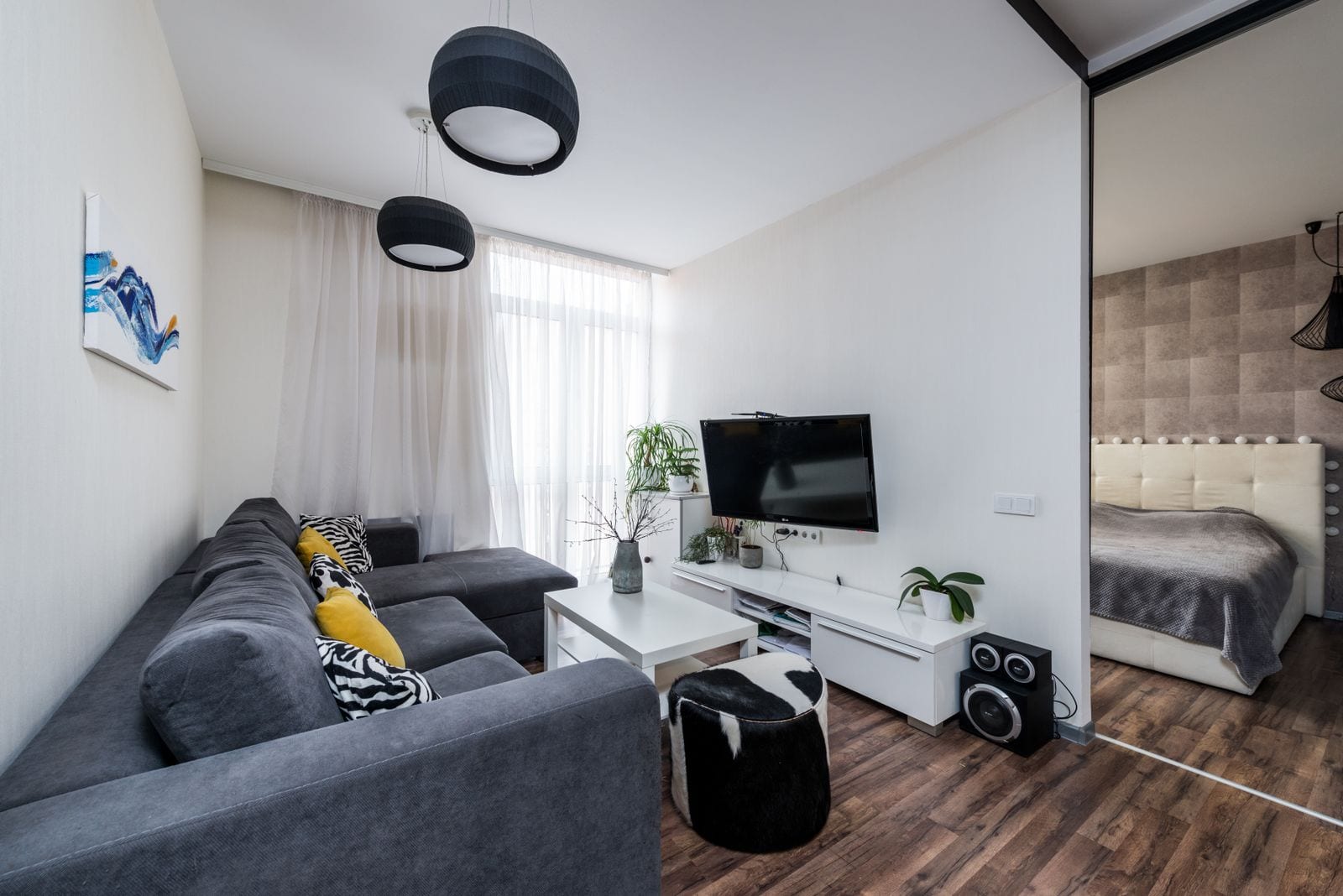 A bright, furnished modern living space with a sofa and media console in a South Plains home.